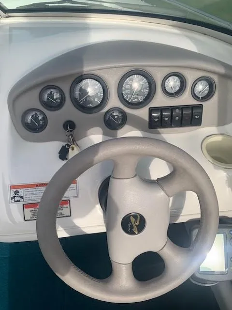 Slide: The Image of 1998 Sea Ray 185 Bow Rider dashboard with steering wheel and gauges. - 5