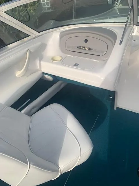 Slide: The Image of 1998 Sea Ray 185 Bow Rider interior with white seating and blue carpet. - 6