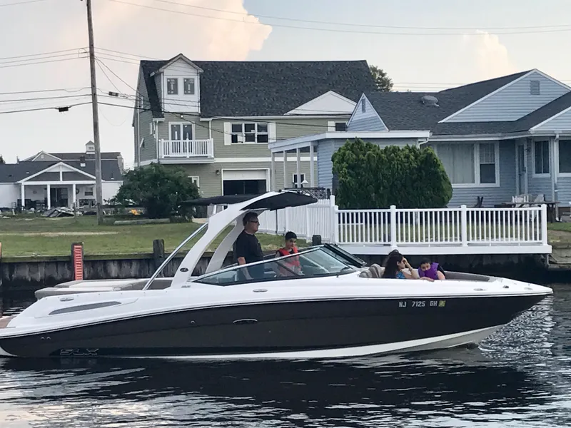Slide: The Image of 2013 Sea Ray 250 SLX boat cruising near waterfront homes. - 9