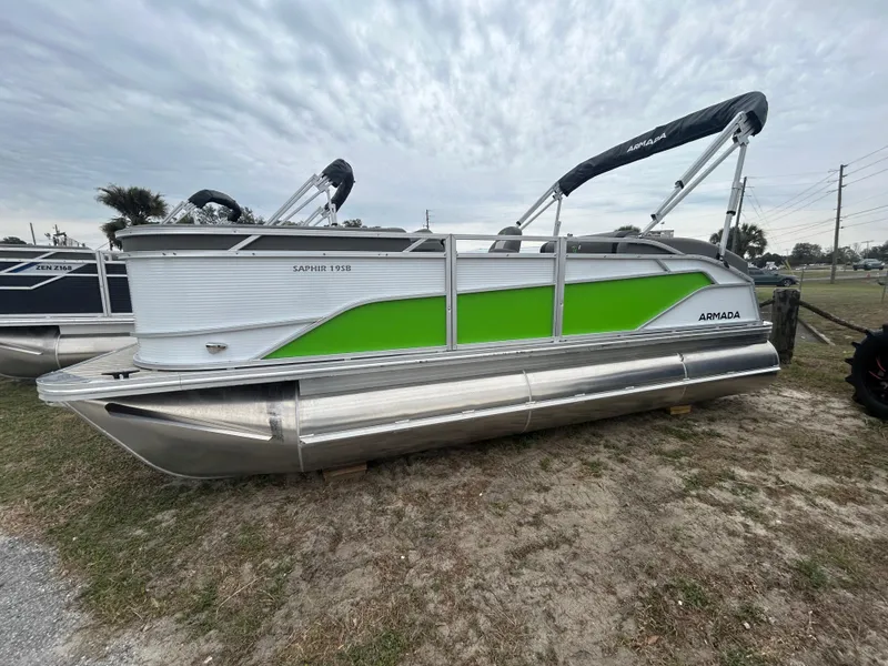The Image of 2025 Armada Saphir 19SB pontoon boat with green accents on display outdoors. - 1