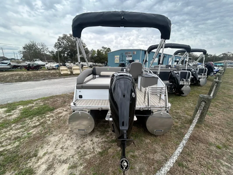 Slide: The Image of 2025 Armada Saphir 19SB pontoon boat with outboard motor, parked outdoors. - 4