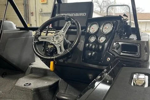 Slide: The Image of 2022 Tracker Targa 18 WT boat dashboard with steering wheel and gauges. - 5
