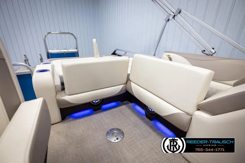 Slide: The Image of 2025 Avalon LSZ VRB boat interior with white seating and blue LED lighting. - 25