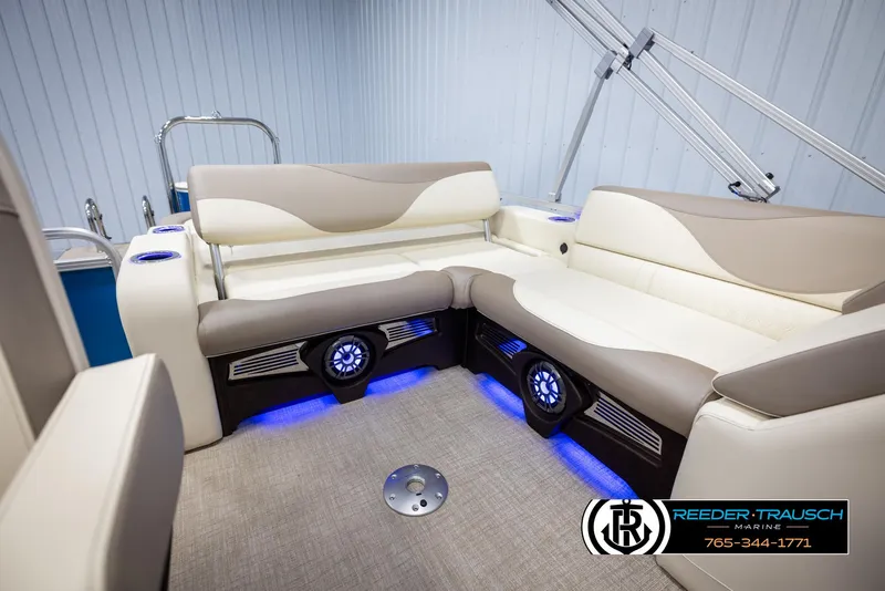 Slide: The Image of 2025 Avalon LSZ VRB boat interior with beige seating and blue LED lighting. - 26