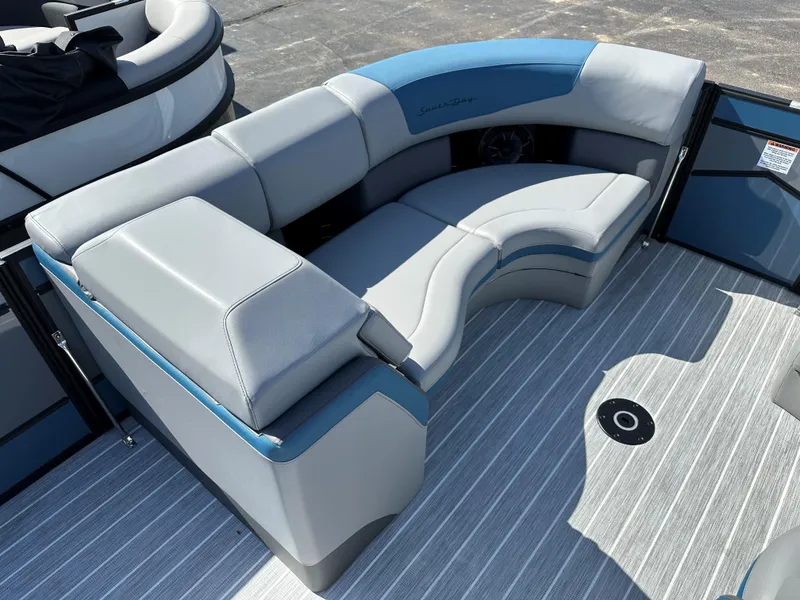 Slide: The Image of 2025 South Bay 523 ULE boat interior with gray and blue seating on striped flooring. - 10
