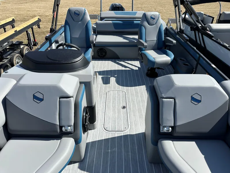 Slide: The Image of 2025 South Bay 523 ULE pontoon boat interior with gray and blue seating. - 13