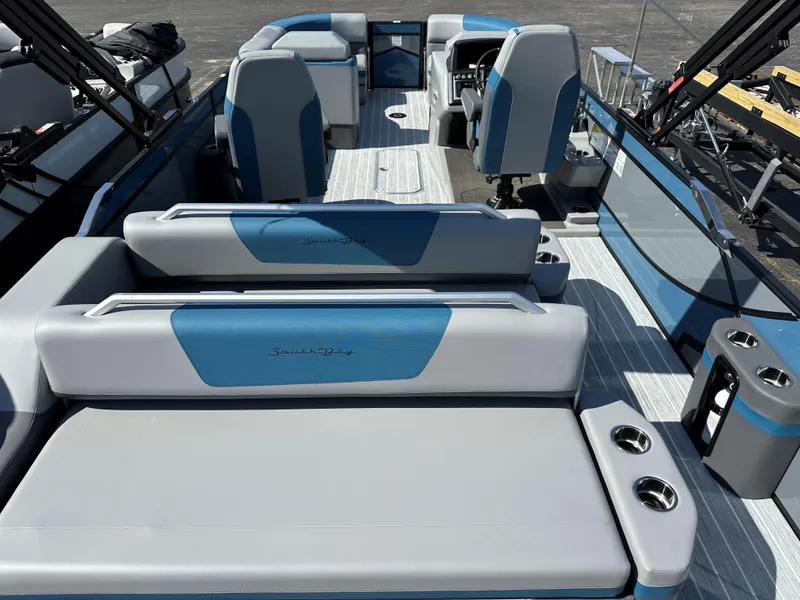 Slide: The Image of 2025 South Bay 523 ULE boat interior with blue and gray seating and modern design. - 4