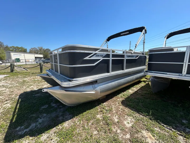 The Image of 2025 Armada Z-168 pontoon boat on display outdoors under clear blue sky. - 0