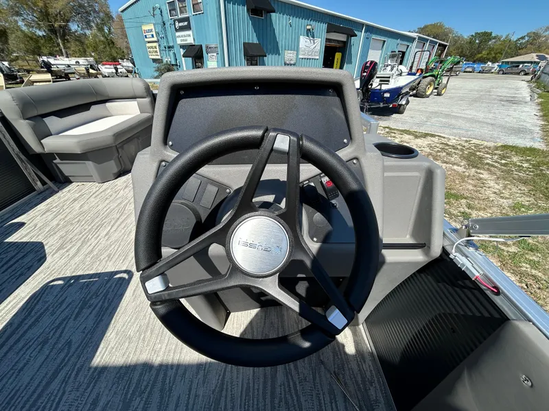 Slide: The Image of Steering wheel of 2025 Armada Z-168 boat, outdoor setting, blue building in background. - 8