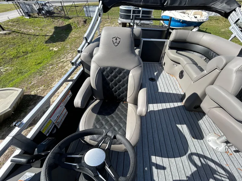 Slide: The Image of 2025 Armada Drakkar 23QL boat interior with plush seating and modern steering wheel. - 10
