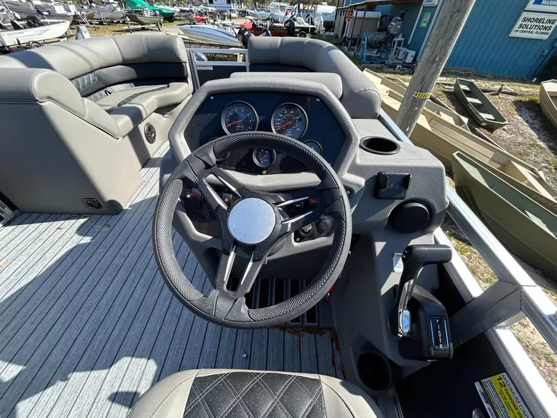 Slide: The Image of 2025 Armada Drakkar 23QL boat interior with steering wheel and seating. - 11