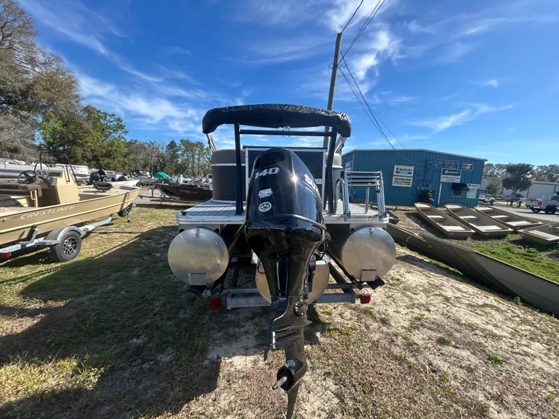 Slide: The Image of 2025 Armada Drakkar 23QL boat with outboard motor, parked outdoors under a clear blue sky. - 3