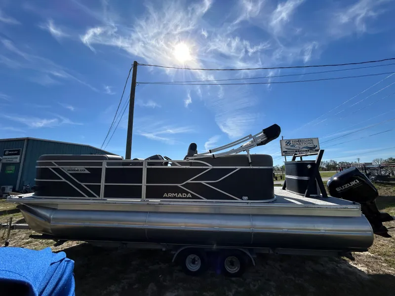 Slide: The Image of 2025 Armada Drakkar 23QL pontoon boat under a bright blue sky. - 5