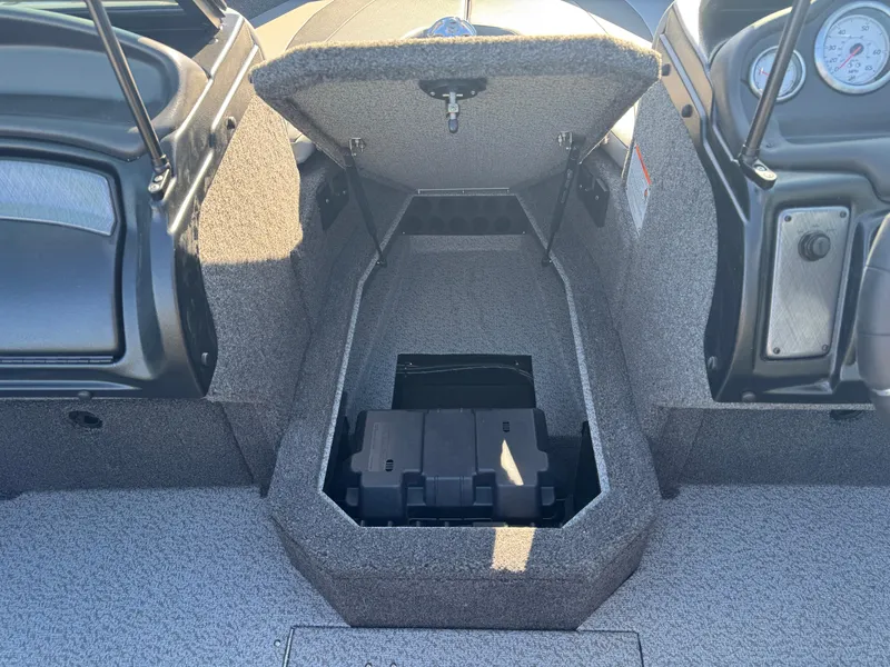 Slide: The Image of 2025 Lund 1875 Crossover XS boat interior with open storage compartment. - 9