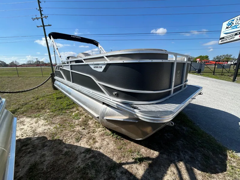Slide: The Image of 2025 Armada Saphir 21SB pontoon boat parked on grass under a clear blue sky. - 4