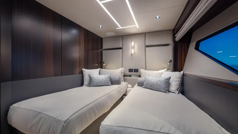 Slide: The Image of Luxurious twin bedroom in 2025 Sunseeker 88 Yacht with modern design and ambient lighting. - 32