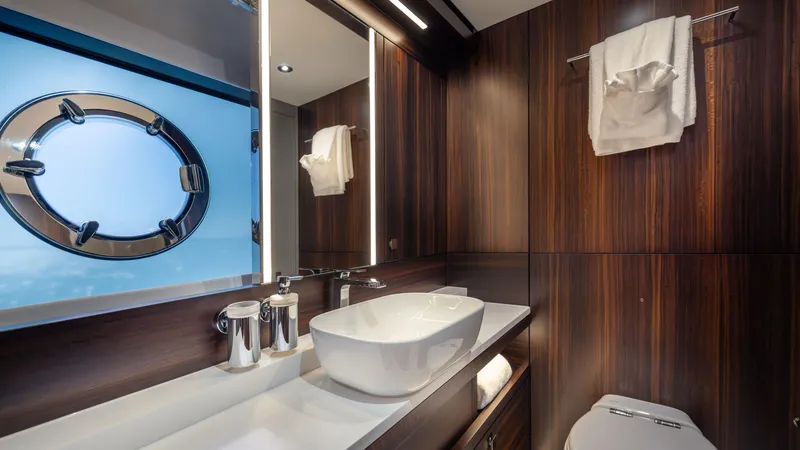 Slide: The Image of Luxurious bathroom in 2025 Sunseeker 88 Yacht with modern fixtures and porthole window. - 33