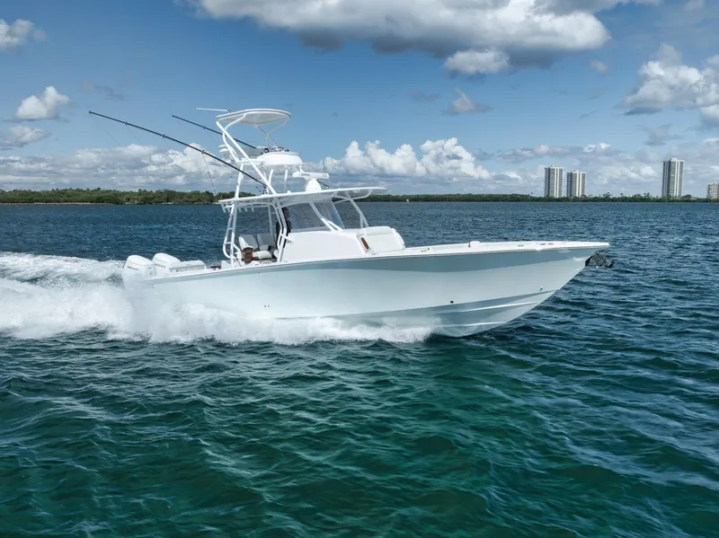 The Image of 2023 Jupiter 40 boat cruising on open water under a partly cloudy sky. - 0