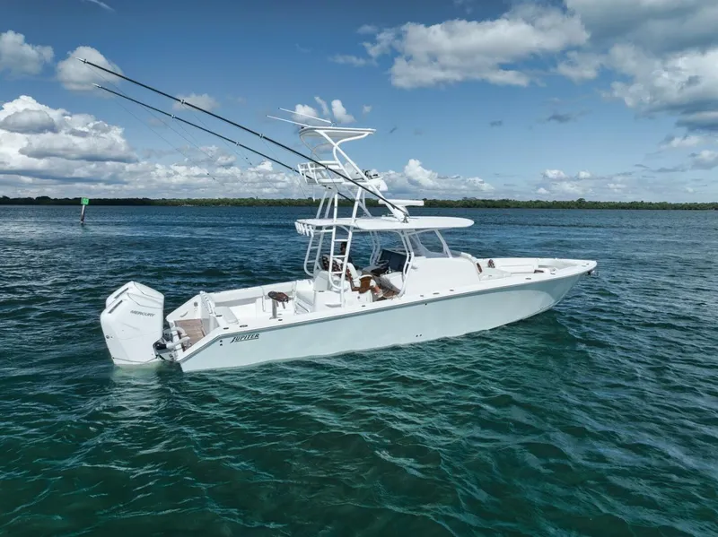 Slide: The Image of 2023 Jupiter 40 boat on open water under a partly cloudy sky. - 11