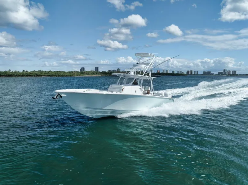 Slide: The Image of 2023 Jupiter 40 boat cruising on open water under a clear blue sky. - 2