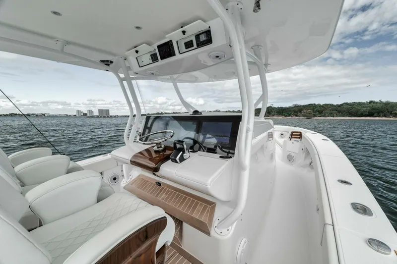 Slide: The Image of 2023 Jupiter 40 boat interior with helm, luxurious seating, and ocean view. - 20