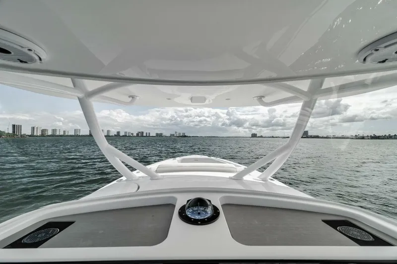 Slide: The Image of 2023 Jupiter 40 boat on water, city skyline in background, overcast sky. - 24
