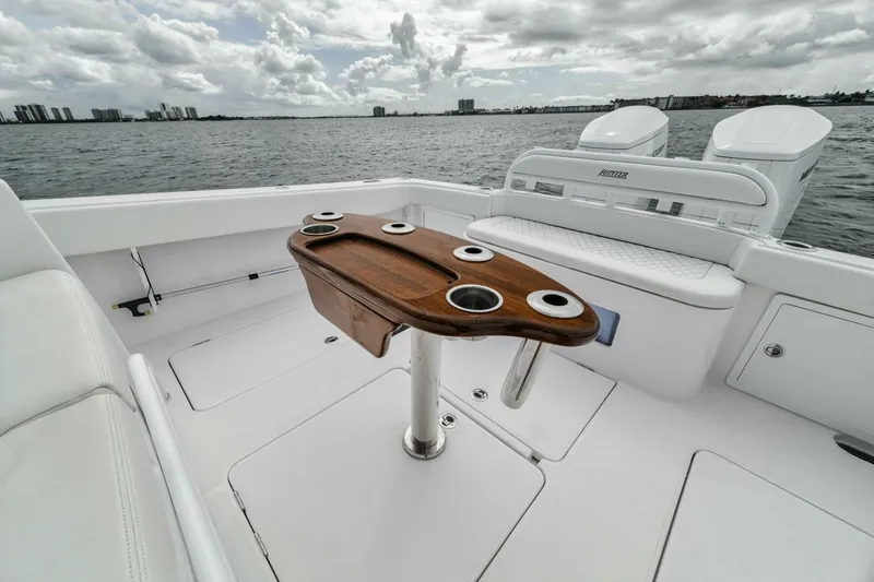 Slide: The Image of Luxury Jupiter 40 boat deck with wooden table, cup holders, and ocean view, 2023 model. - 30