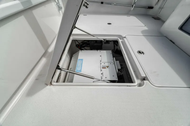 Slide: The Image of 2023 Jupiter 40 boat storage compartment with open hatch, showcasing interior equipment. - 31