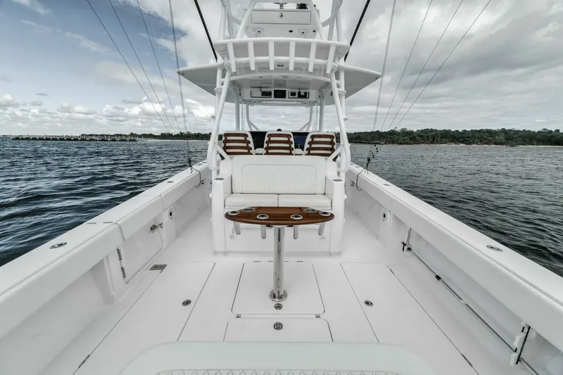 Slide: The Image of 2023 Jupiter 40 boat on water, featuring spacious deck and seating. - 35