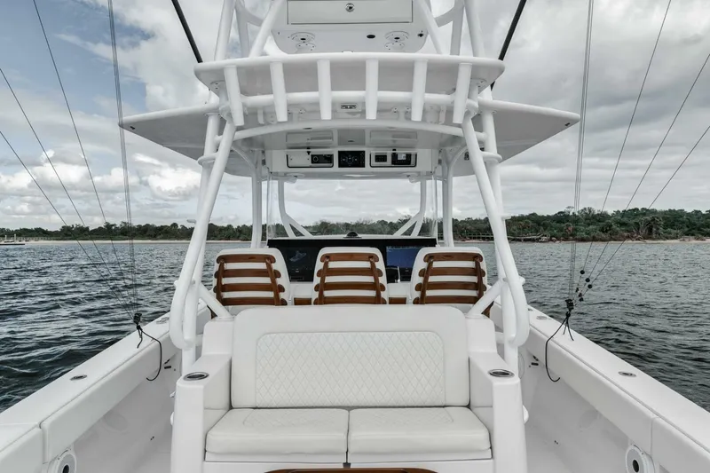 Slide: The Image of 2023 Jupiter 40 boat interior with seating, on a calm water body. - 36