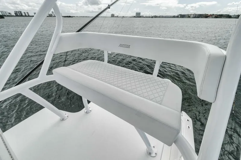 Slide: The Image of 2023 Jupiter 40 boat with white cushioned seating, overlooking calm waters. - 39