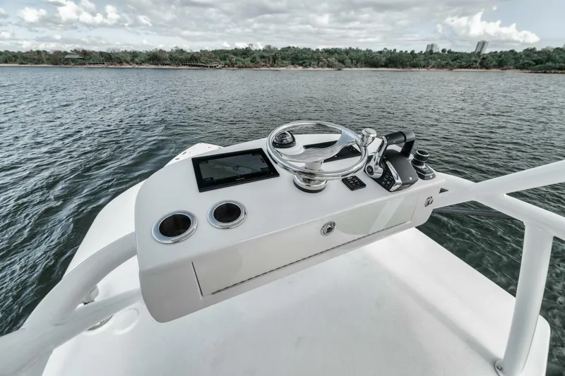 Slide: The Image of Control panel of 2023 Jupiter 40 boat on water, featuring modern navigation equipment. - 40