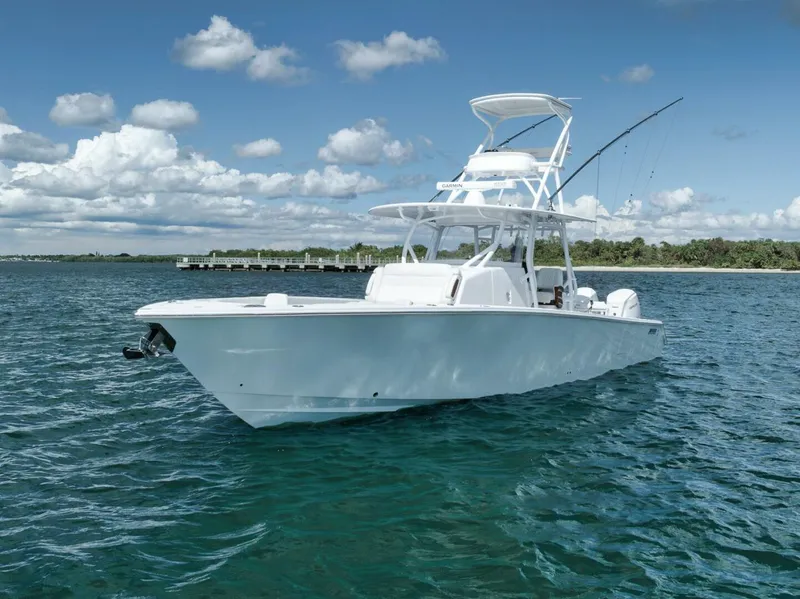 Slide: The Image of 2023 Jupiter 40 boat on clear blue water under a partly cloudy sky. - 6