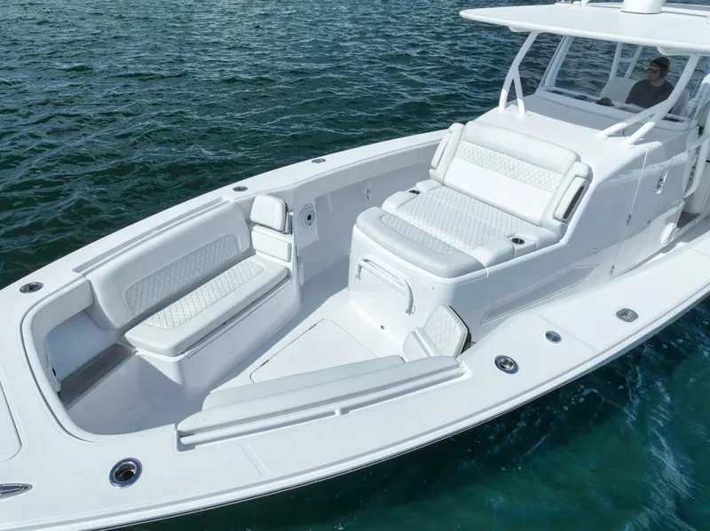 Slide: The Image of 2023 Jupiter 40 boat with spacious white seating on calm water. - 7