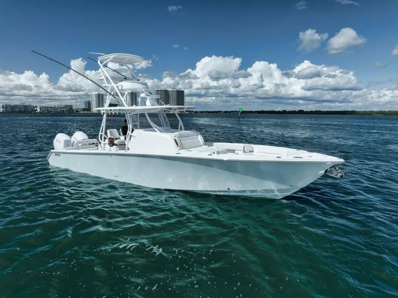 Slide: The Image of 2023 Jupiter 40 boat on clear blue water under a partly cloudy sky. - 9