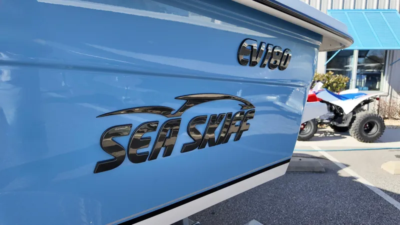 Slide: The Image of 2025 Carolina Skiff EV180 Sea Skiff, blue exterior, close-up view. - 2