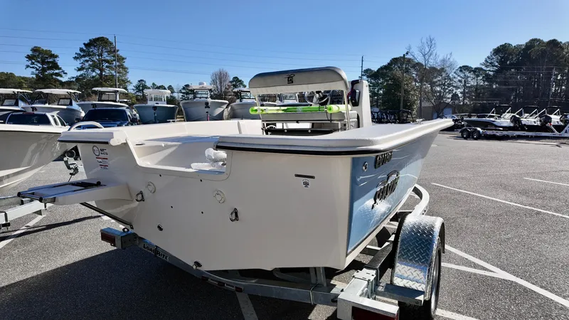 Slide: The Image of 2025 Carolina Skiff EV180 Sea Skiff on trailer in parking lot, sunny day. - 3