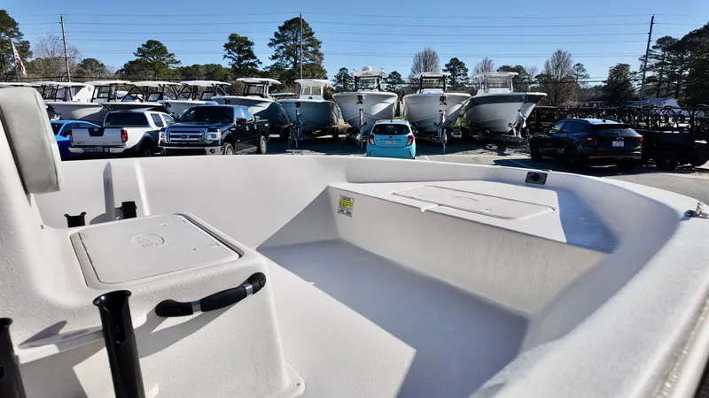 Slide: The Image of 2025 Carolina Skiff EV180 Sea Skiff in a boat dealership lot. - 5