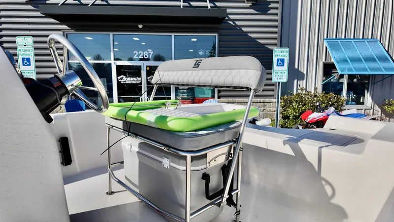 Slide: The Image of 2025 Carolina Skiff EV180 Sea Skiff boat interior with seating and steering wheel. - 8