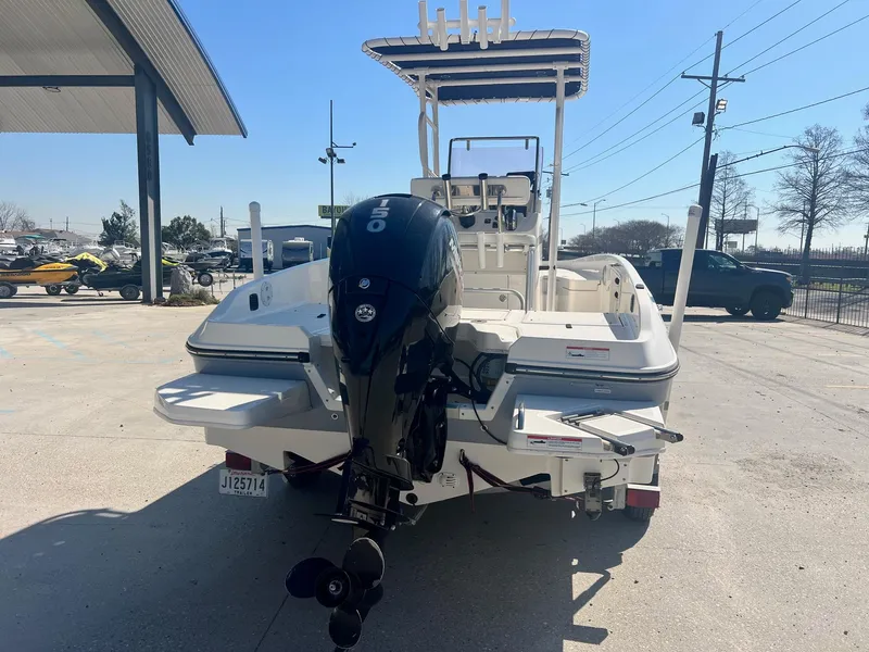 Slide: The Image of 2022 Bayliner Trophy T21Bay boat with outboard motor, parked outdoors. - 3