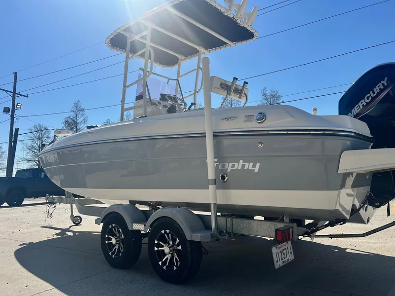 Slide: The Image of 2022 Bayliner Trophy T21Bay boat on trailer, parked outdoors, side view. - 5