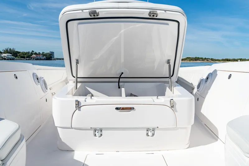 Slide: The Image of 2023 Intrepid 427 Nomad SE boat with open storage compartment, showcasing sleek design. - 15