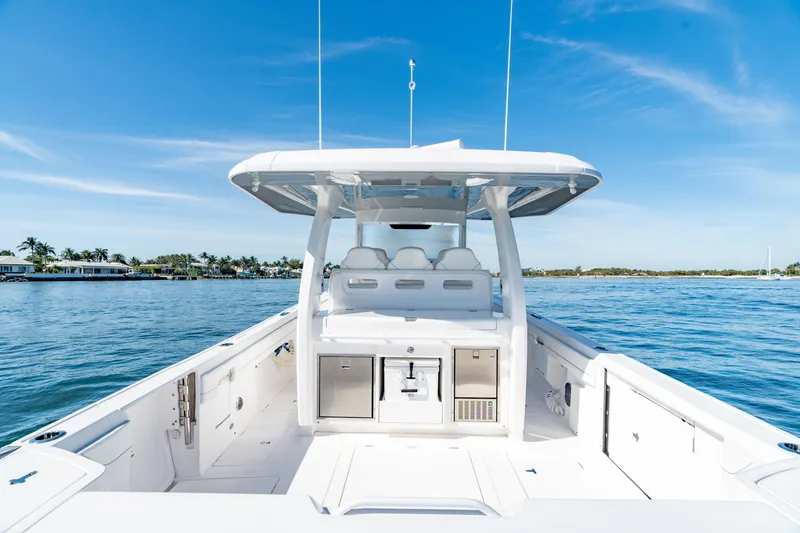 Slide: The Image of 2023 Intrepid 427 Nomad SE boat on calm blue water under clear sky. - 17