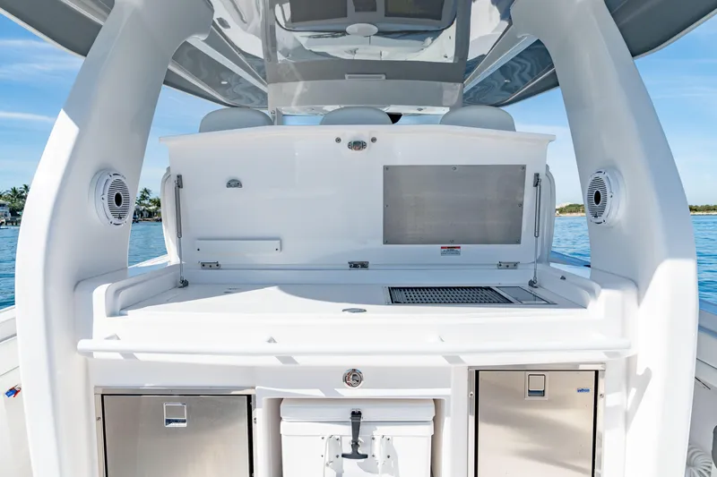 Slide: The Image of 2023 Intrepid 427 Nomad SE boat interior with sleek white cabinetry and ocean view. - 18