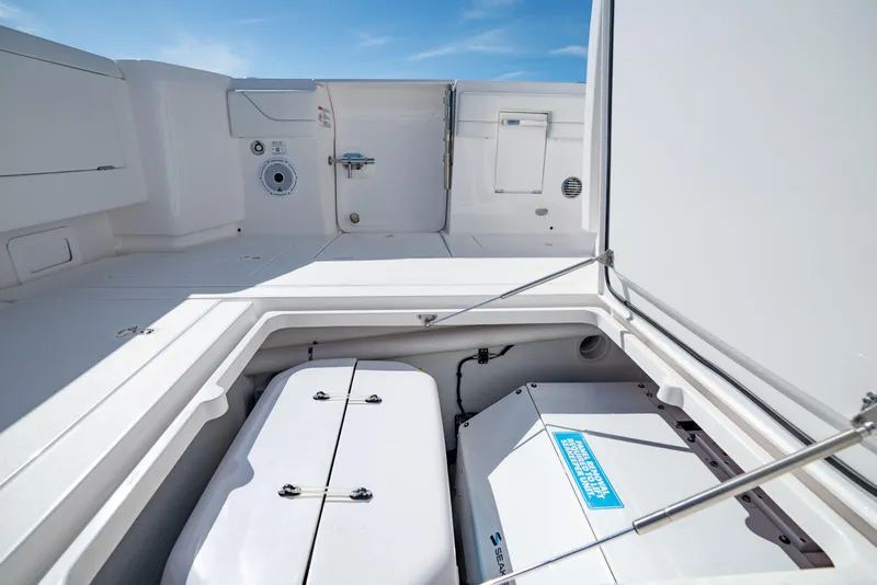 Slide: The Image of 2023 Intrepid 427 Nomad SE boat storage compartment with open hatch, showcasing interior features. - 20