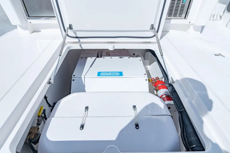 Slide: The Image of 2023 Intrepid 427 Nomad SE boat storage compartment with fire extinguisher. - 21