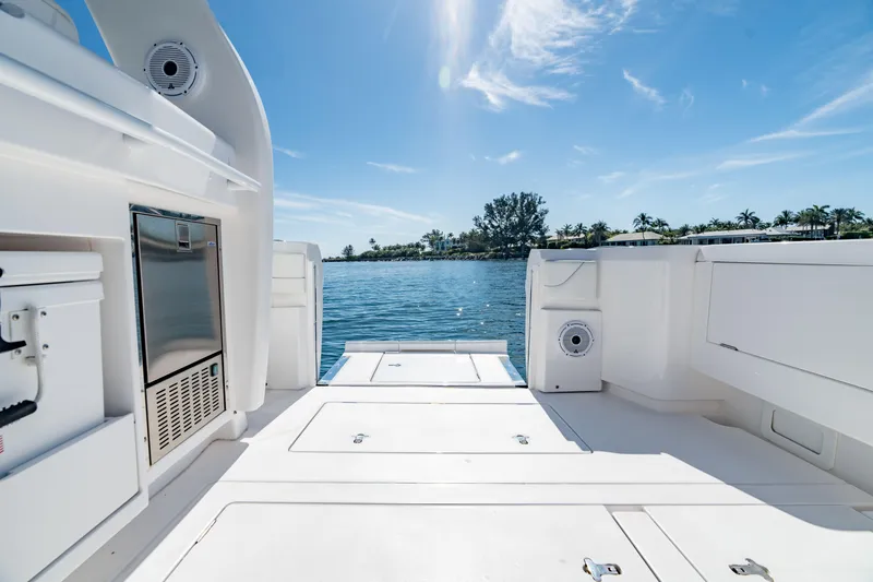 Slide: The Image of 2023 Intrepid 427 Nomad SE boat deck with ocean view under clear blue sky. - 22