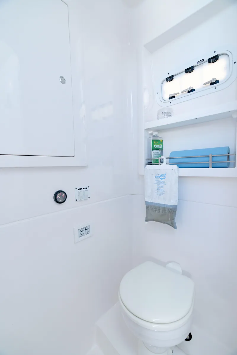 Slide: The Image of 2023 Intrepid 427 Nomad SE boat bathroom with toilet and storage shelves. - 24