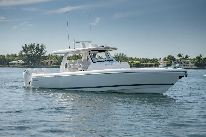 Slide: The Image of 2023 Intrepid 427 Nomad SE boat cruising on calm waters under a clear sky. - 3