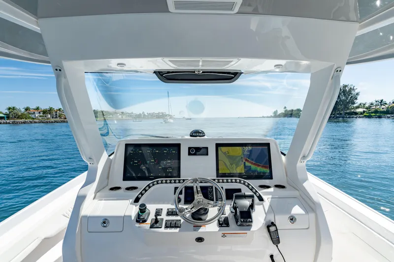 Slide: The Image of 2023 Intrepid 427 Nomad SE helm with navigation screens on open water. - 7